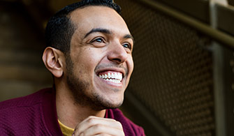 latino man smiling wide with white teeth