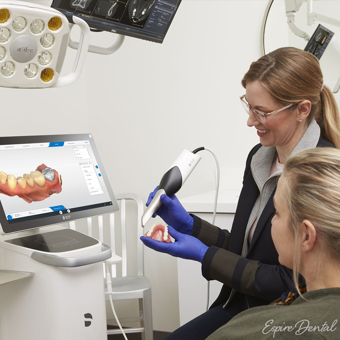 female dental professional explaining procedure to female patient