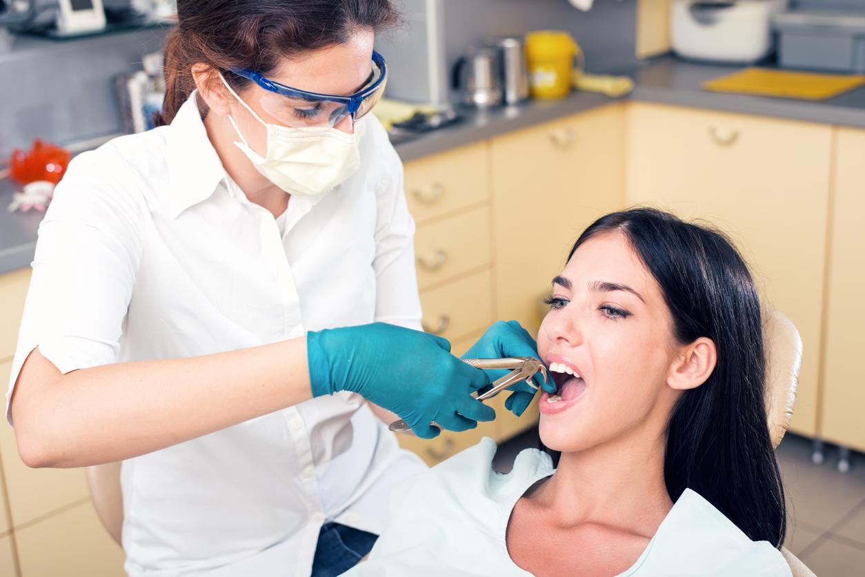 woman sitting in dentist's chair having a procedure